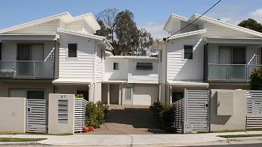Small block of town-houses sharing a similar design.